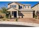 Charming two-story home boasts a well-maintained lawn, a brick driveway, and an attached two-car garage at 2628 Ferrara St, Henderson, NV 89044
