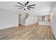 Open concept living room with wood floors, ceiling fan, and stairs to the second floor at 2628 Ferrara St, Henderson, NV 89044