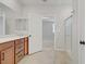 Bathroom with double vanity, shower, and views into bedroom at 2628 Ferrara St, Henderson, NV 89044