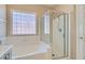 Bathroom showcasing a soaking tub and glass-enclosed shower at 2668 Ivoryhill St, Las Vegas, NV 89135