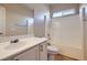 Bathroom with white vanity, mirror, and shower-tub combination with white tile surround at 2668 Ivoryhill St, Las Vegas, NV 89135
