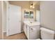 This bathroom features a white vanity, framed mirror, toilet and updated fixtures at 2668 Ivoryhill St, Las Vegas, NV 89135