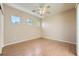 Bright bedroom with hardwood floors, neutral color scheme, three horizontal windows, and ceiling fan at 2668 Ivoryhill St, Las Vegas, NV 89135