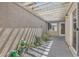 Serene covered courtyard with a pebble garden and lush plants, offering a private outdoor retreat at 2668 Ivoryhill St, Las Vegas, NV 89135