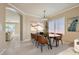 Dining room with modern table and chairs, colorful art, and natural light at 2668 Ivoryhill St, Las Vegas, NV 89135