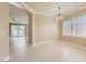 A neutral-toned dining room with tile floors, a chandelier, and shuttered windows at 2668 Ivoryhill St, Las Vegas, NV 89135
