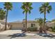 Inviting single-story home featuring mature palm trees and a well-maintained front yard at 2668 Ivoryhill St, Las Vegas, NV 89135