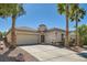 Charming single-story home with desert landscaping, palm trees and a spacious three-car garage at 2668 Ivoryhill St, Las Vegas, NV 89135