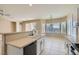 Open kitchen with modern appliances, tile floors, and a breakfast bar at 2668 Ivoryhill St, Las Vegas, NV 89135