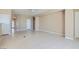 Spacious living room features tile flooring and neutral colors with multiple access points at 2668 Ivoryhill St, Las Vegas, NV 89135