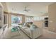 Cozy living room with modern sectional, adjacent to the open kitchen and backyard pool view at 2668 Ivoryhill St, Las Vegas, NV 89135