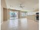 Open-concept living area with tile floors, ceiling fan, and a view of the backyard pool at 2668 Ivoryhill St, Las Vegas, NV 89135