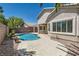 Private backyard featuring a sparkling pool, patio area, and lush landscaping for relaxation at 2668 Ivoryhill St, Las Vegas, NV 89135