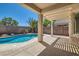 Inviting backyard oasis with a sparkling blue pool, covered patio, and lush landscaping at 2668 Ivoryhill St, Las Vegas, NV 89135