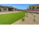 Backyard with artificial turf for easy maintenance, stone landscaping, and lovely patio at 281 Gandara St, Las Vegas, NV 89138