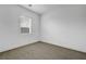 Bright bedroom with neutral carpet, white walls, and a window for natural light at 281 Gandara St, Las Vegas, NV 89138