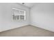 Well-lit bedroom features neutral carpet, white walls, and a large window at 281 Gandara St, Las Vegas, NV 89138
