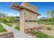 Inviting entrance to Arcadia Ridge with stone signage and manicured landscaping for a prestigious welcome at 281 Gandara St, Las Vegas, NV 89138