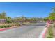Gated community entrance with brick accents and lush landscaping, ensuring privacy and curb appeal at 281 Gandara St, Las Vegas, NV 89138