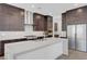 Spacious kitchen features dark wood cabinets, quartz countertops, and stainless steel appliances at 281 Gandara St, Las Vegas, NV 89138