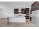 Modern kitchen boasts a large island, stainless steel appliances, and ample cabinet space at 281 Gandara St, Las Vegas, NV 89138