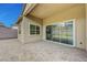 Covered patio with brick pavers, sliding glass doors and well-maintained exterior of the home at 281 Gandara St, Las Vegas, NV 89138