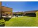 A large backyard with a pool, seating, and manicured green lawn provides ample outdoor space at 29 Blue Valley Dr, Henderson, NV 89002
