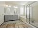 Bright bathroom with double vanity, large soaking tub, and glass-enclosed shower at 29 Blue Valley Dr, Henderson, NV 89002