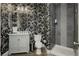 Stylish half-bath featuring floral wallpaper, modern vanity and tiled shower stall at 29 Blue Valley Dr, Henderson, NV 89002