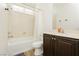 Practical bathroom with a shower-tub, dark cabinets, and tile flooring at 29 Blue Valley Dr, Henderson, NV 89002