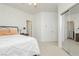 Neutral bedroom with a mirrored closet, access to another room, and simple decor at 29 Blue Valley Dr, Henderson, NV 89002