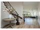 Inviting entryway with staircase, table with flowers, and a glimpse of the living room beyond at 29 Blue Valley Dr, Henderson, NV 89002