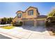 Charming two-story home boasts a three-car garage, landscaped front yard, and desirable curb appeal at 29 Blue Valley Dr, Henderson, NV 89002