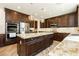 Gourmet kitchen with granite countertops, a large island, and modern stainless steel appliances at 29 Blue Valley Dr, Henderson, NV 89002