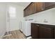 Convenient laundry room with modern washer and dryer, white cabinets, and sink at 29 Blue Valley Dr, Henderson, NV 89002