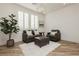 Cozy living room with modern decor, wood floors, and bright natural lighting at 29 Blue Valley Dr, Henderson, NV 89002