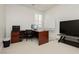 Bright home office with a desk, white board, television, and neutral carpet at 29 Blue Valley Dr, Henderson, NV 89002