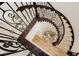 Elegant staircase with wrought iron railing and carpeted steps at 29 Blue Valley Dr, Henderson, NV 89002
