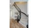 Elegant staircase with carpeted steps and decorative iron railing, with a table underneath at 29 Blue Valley Dr, Henderson, NV 89002