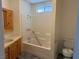 Clean bathroom with tub-shower combination, knotty pine vanity, and tile flooring at 311 Glenoaks St, Pahrump, NV 89048