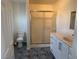 Bathroom featuring a shower with sliding glass doors, toilet, and single sink vanity at 311 Glenoaks St, Pahrump, NV 89048