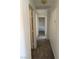 Hallway with carpet, neutral walls and trim, leading to several bedrooms at 311 Glenoaks St, Pahrump, NV 89048