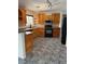 Kitchen featuring granite countertops, knotty pine cabinetry, recessed lighting, and a black appliance package at 311 Glenoaks St, Pahrump, NV 89048