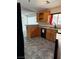 Well-lit kitchen with knotty pine cabinetry, granite countertops, and a black appliance package at 311 Glenoaks St, Pahrump, NV 89048