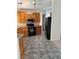 Well-lit kitchen with knotty pine cabinetry, granite countertops, and a black appliance package at 311 Glenoaks St, Pahrump, NV 89048
