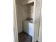 Conveniently located laundry area with white washer and dryer, and bi-fold doors for storage at 311 Glenoaks St, Pahrump, NV 89048