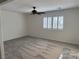 The living room has new carpet, neutral paint, shuttered windows, and ceiling fan at 311 Glenoaks St, Pahrump, NV 89048