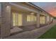 Exterior view of covered patio with fan, lights and lush backyard area for entertaining at 3155 Dalmazia Ave, Henderson, NV 89044