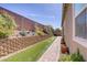 A beautifully landscaped backyard featuring a stone retaining wall with a water feature at 3155 Dalmazia Ave, Henderson, NV 89044