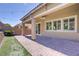 Covered patio featuring a ceiling fan, brick pavers, and views of landscaped backyard at 3155 Dalmazia Ave, Henderson, NV 89044